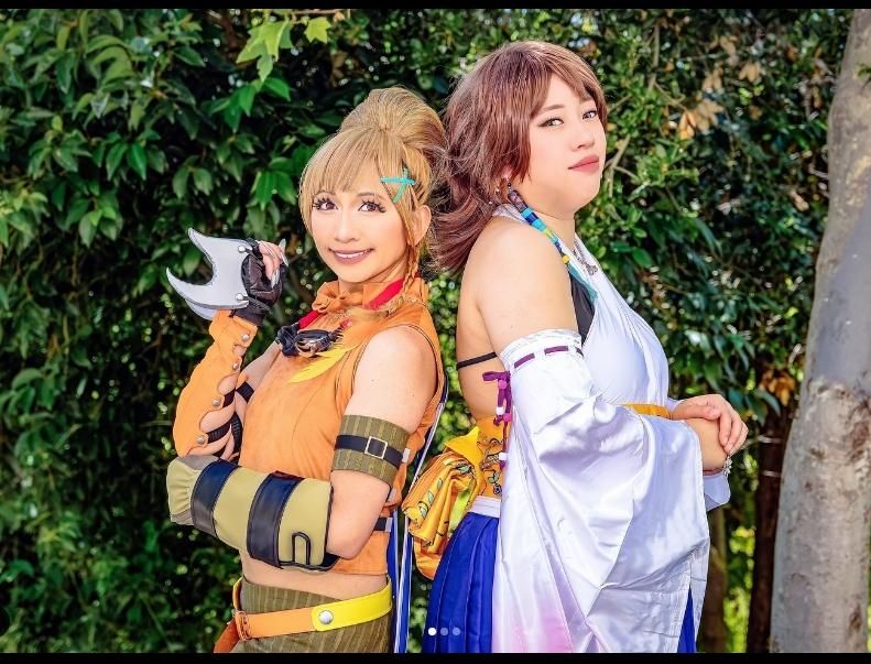 Outdoor forest group cosplay shot by @itsjosielicious, Yuna with gradient white-pink wide sleeves kimono set paired with Rikku orange adventurer costume, full character outfit display