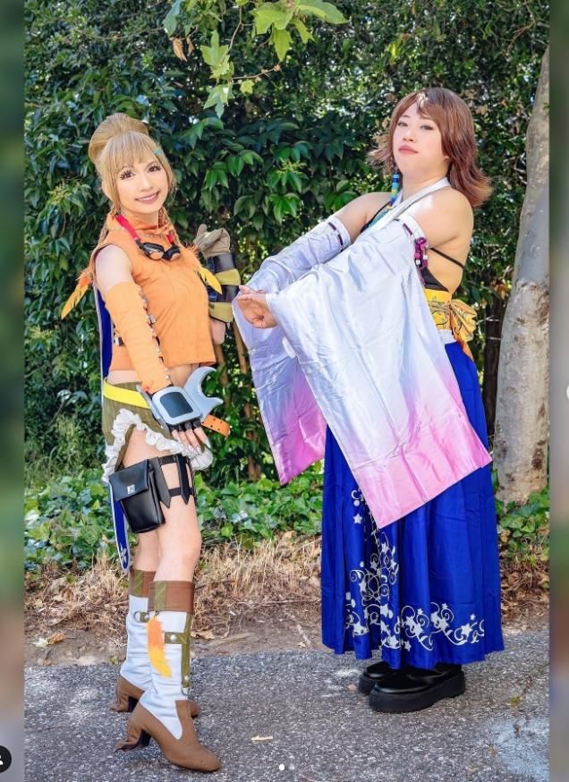 Full length outdoor customer photo by @itsjosielicious, Yuna in star printed navy long skirt & gradient sleeves, Rikku complete orange adventurer cos with gauntlets and boots