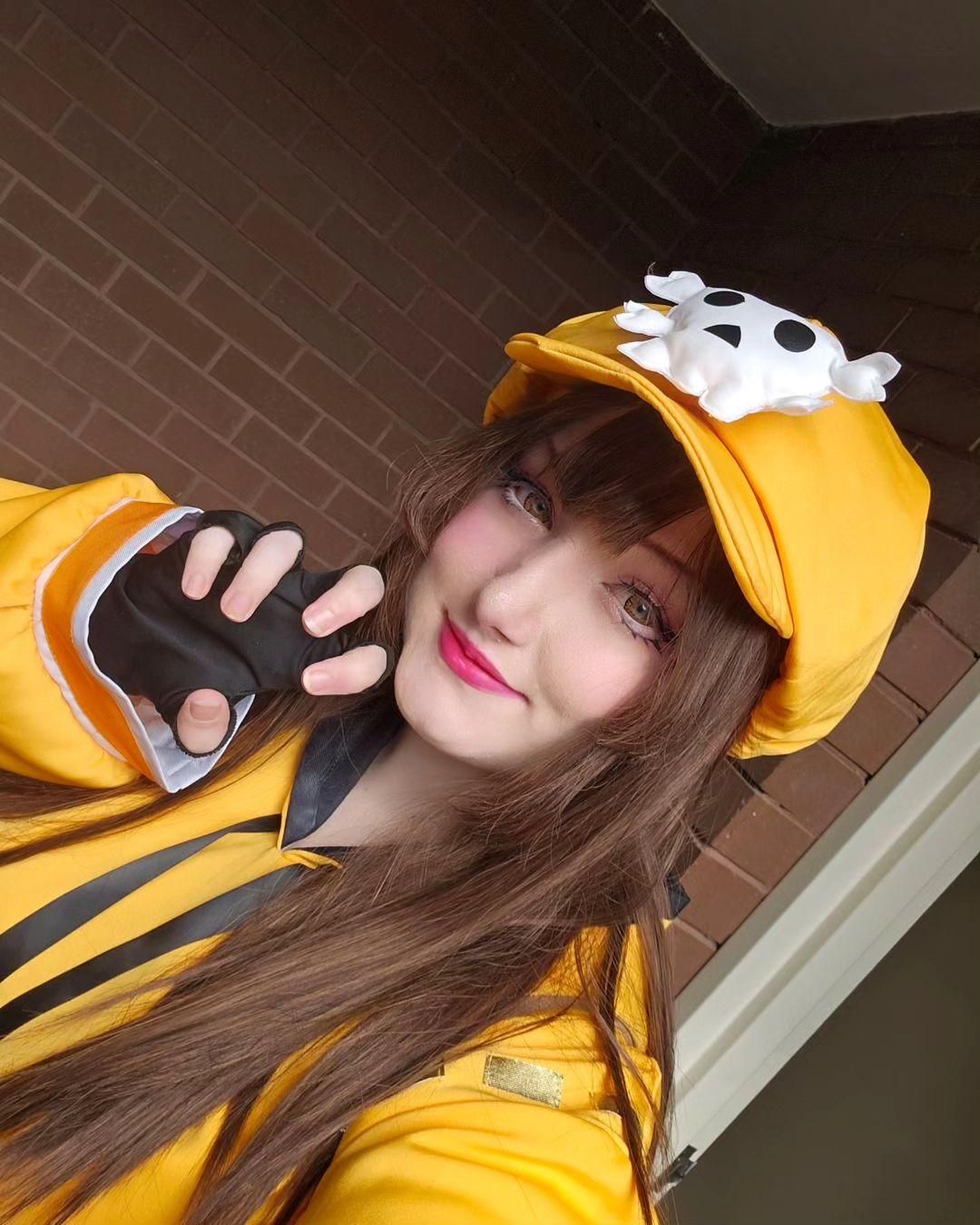 Selfie close-up customer shot of Guilty Gear Strive May coser @Kiri, detailed view of the skull beret, brown long wig and hoodie fabric texture