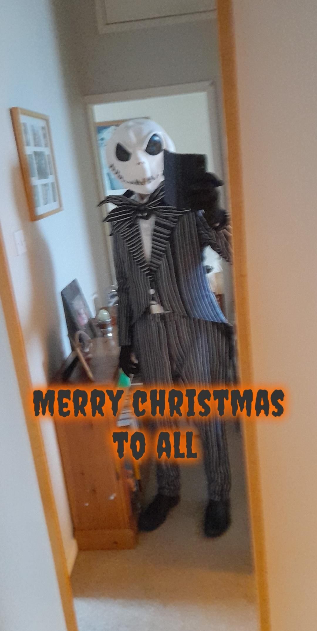 Home mirror selfie contributed by @Skelly in complete Jack cos set including full pinstripe suit, jagged bow tie and official latex skull mask, Halloween holiday text overlay added on layout
