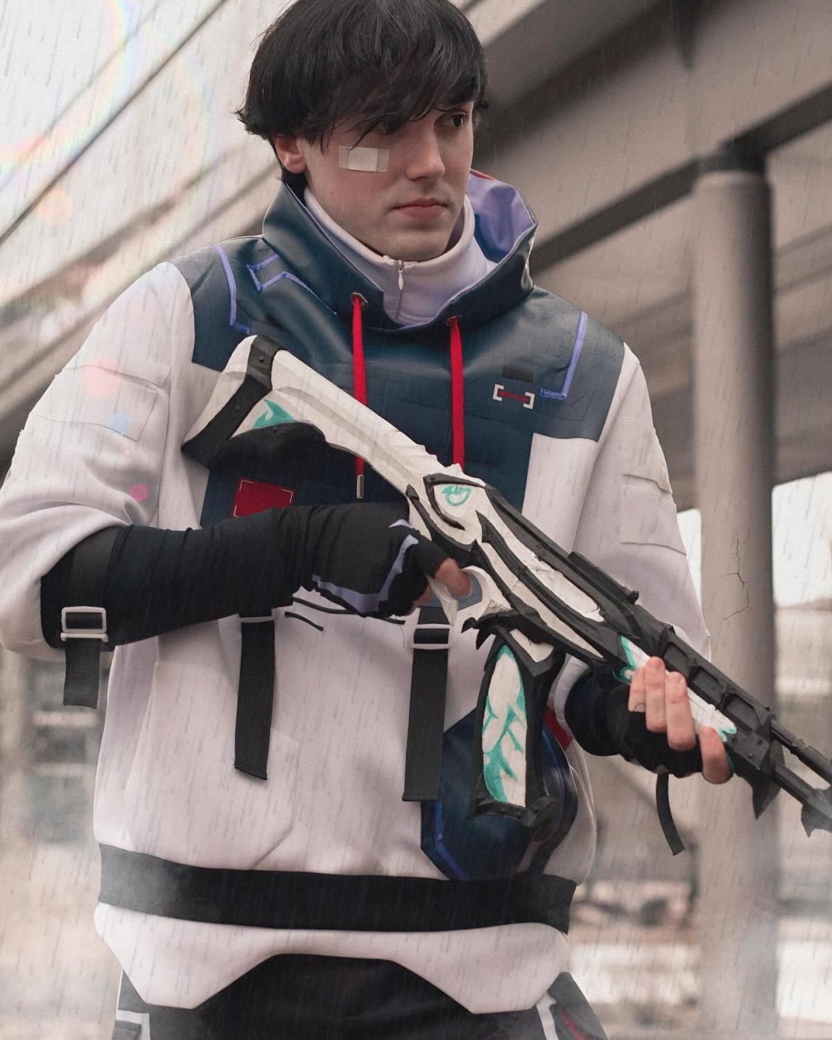 Outdoor rainy scene customer portrait by @sett.cos, holding game-accurate white sci-fi rifle prop, full ISO top set and arm wrap tactical gloves, bandage detail on forehead to replicate in-game character styling